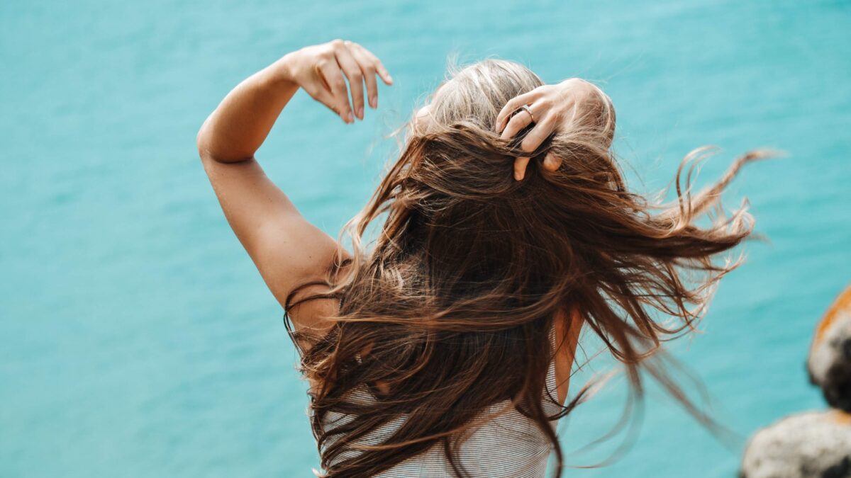 woman flipping hair in wind